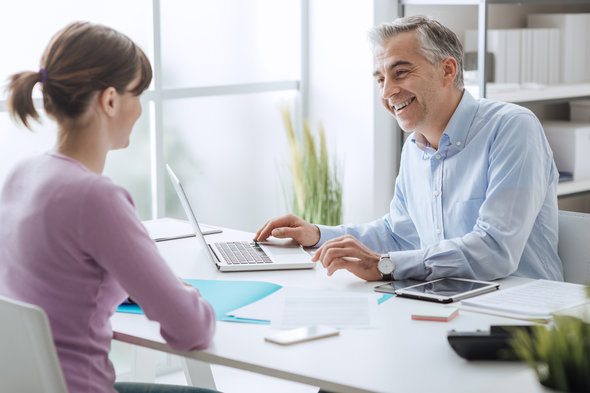 A wealth manager sitting down with a client.