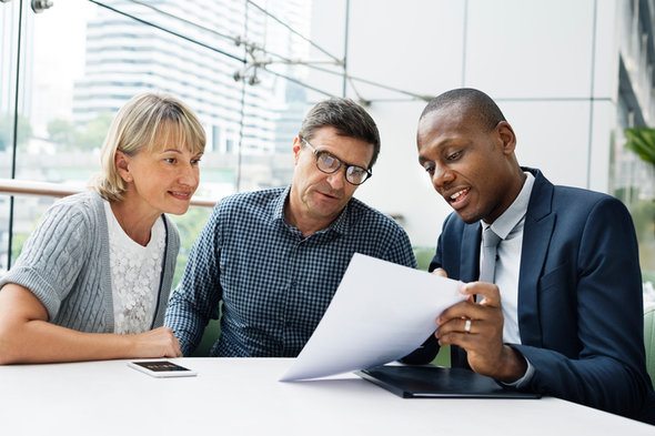A financial advisor meets with clients.