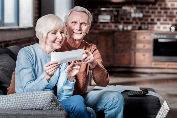 A husband and wife review their Social Security check.
