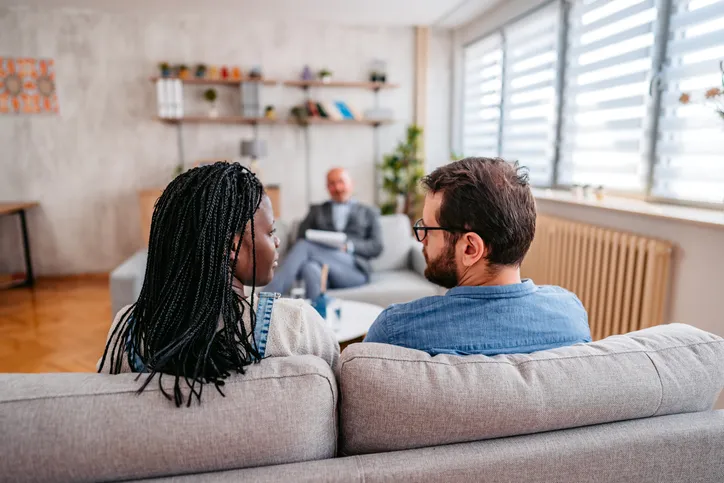 A couple meeting with a financial advisor to discuss the division of assets and debt.